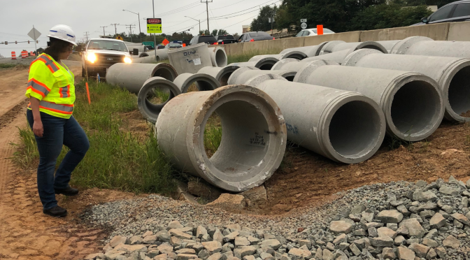 Heavy construction materials staged roadside, with New Form Supply engineers on site to prevent costly mistakes.